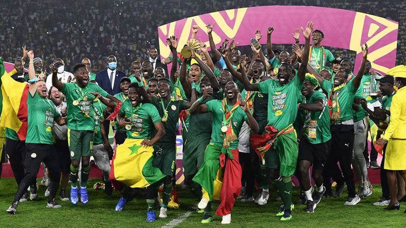 Senegal's players celebrate with the trophy after beating Egypt to win their first-ever Africa Cup of Nations Title on February 6 2022 | Senegal Celebrates Her First African Cup of Nations Victory